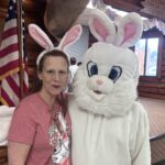 The Easter Bunny Stands with a Volunteer